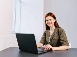 pngtree a joyful lady productively working on a laptop in a luminous workplace photo image 51133116